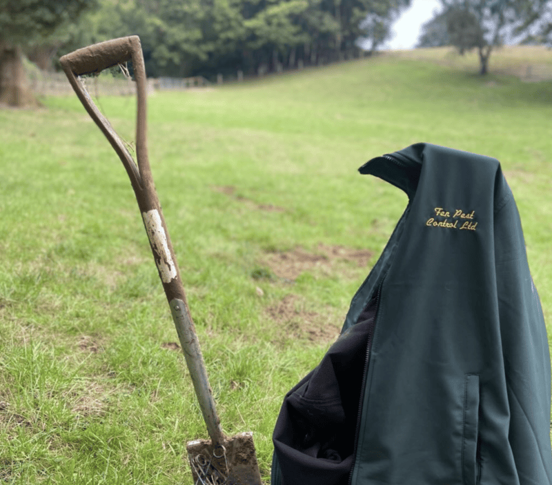A shovel with a branded Fen Pest fleece next to it